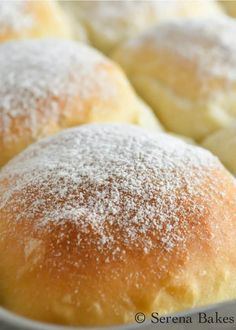 powdered sugar on top of rolls in a pan