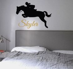 a bedroom with a horse and rider decal on the wall