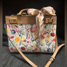 Nwot Aldo Floral Shoulder Or Crossbody Bag. This Bag Is A Beautiful Floral Print With A Bow That Ties On The Handles. It Also Comes With A Strap So You Can Carry It On Your Shoulder Or As A Crossbody Bag. The Strap Is Adjustable. The Hardware Is Gold. I Have Included Pictures With The Measurements. It Has Three Pockets Inside, One Zips & A Compartment On The Outside That Zips. This Bag Has Never Been Used!!! Multicolor Satchel Box Bag, Multicolor Box Bag With Detachable Handle, Multicolor Crossbody Satchel With Top Carry Handle, Multicolor Crossbody Satchel With Top Handle, Multicolor Shoulder Bag With Top Carry Handle For Spring, Yellow Tote Bags For Day Out, Yellow Tote Bag For Day Out, Chic Multicolor Bags For Day Out, Multicolor Spring Bag With Top Carry Handle