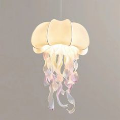 a white light hanging from a ceiling with jelly like material on it's sides