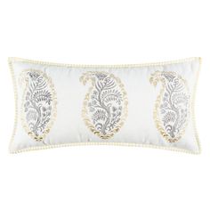 a white and gold pillow with an embroidered paisley design