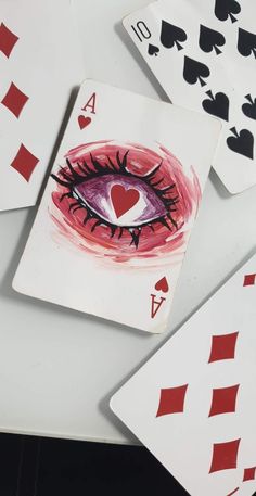 playing cards with an eye painted on them