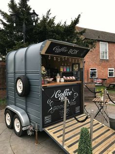 a small coffee cart is parked in front of a house