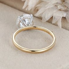 a close up of a diamond ring on a cloth