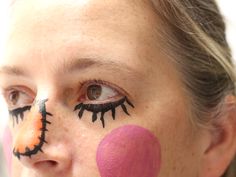 a close up of a person with makeup on their face and painted clowns'noses