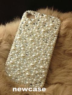 a cell phone case with pearls on it