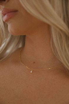 Achieve an elegant look with this dainty gold necklace. Featuring a delicate yet durable gold chain and subtle charm, this necklace stands out without being overbearing. Perfect for adding a finishing touch to your look. 18k gold dipped waterproof hypoallergenic rhinestone charm dainty chain Delicate Gold-plated Chain Necklace, Gold Plated Delicate Chain Necklace, Elegant Recycled Gold Charm Necklace, Delicate Everyday Pendant Chain Necklace, Delicate Pendant Chain Necklace For Everyday, Simple 14k Gold-filled Charm Necklace With Delicate Chain, Simple 14k Gold Filled Charm Necklace With Delicate Chain, Everyday Delicate Clavicle Charm Necklace, Dainty 14k Gold Filled Charm Necklaces For Everyday