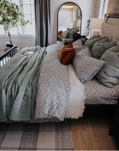 a large bed sitting next to a window in a bedroom