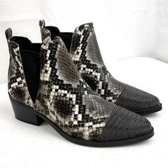 Show Off Your Rebelliously Good Taste In This One-Of-A-Kind Bootie Snakeskin Printed Synthetic Upper 4" Shaft Height Closed Almond Cap Toe With Metal Chain Link Toe. Pull-On Styling Wth Flexible Dual V-Cut Gore Panels Synthetic Lining Lightly Padded Footbed Man-Made Sole 2" Stacked Block Heel *New No Box Black Snake Print Boots For Fall, Trendy Gray Pointed Toe Boots, Trendy Gray Ankle Boots, Black Snake Print Ankle Boots, Gray Boots Medium Width For Fall, Open Toed Booties, Open Toe Ankle Boots, Comfortable Ankle Boots, Peep Toe Ankle Boots