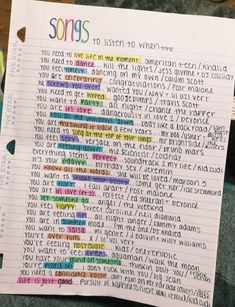 a piece of paper with words written in different colors and sizes on top of it