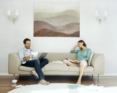 two people sitting on a couch in a living room