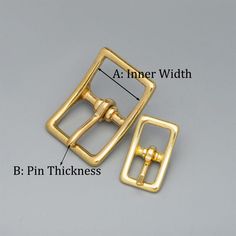 an image of a pair of gold metal buckles with the words b pin thickness