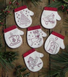 six christmas stockings with embroidered designs on them