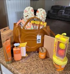 a brown purse sitting on top of a counter next to some bottles and soaps