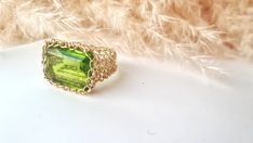 14k Gold Peridot Ring: ♥ Gemstone Type - Peridot (Lab Created) ♥ Gemstone Size - 13x18mm ♥ Gemstone Cut - Rectangle ♥ Metal Type - 14k Gold Filled - (Other options available in the drop-down menu) ♥Tarnish Resistant This Fine 14k Gold Peridot Ring is sure to grab compliments, dress up your casual outfit with a remarkable large stone ring, Gold Statement Ring made of 14k Gold-filled wire crochet statement band with Precious Stone - Peridot Rectangle. This Green Stone ring will make any woman feel Elegant Handmade Peridot Rings, Handmade Elegant Peridot Rings, Elegant Rectangular Peridot Rings, Rectangular Green Peridot Rings, Handmade Green Rectangular Ring, Handmade Elegant Green Crystal Ring, Elegant Handmade Green Crystal Ring, Handmade Yellow Gold Rectangular Rings, Gold Peridot Ring