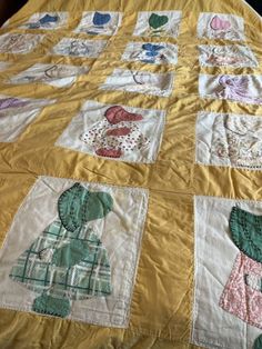 a quilted bedspread with pictures of people on it, including an elephant