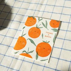 an orange themed greeting card on a checkered tablecloth with the words thanks bunch