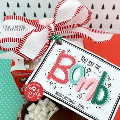 a box filled with marshmallows next to a sign that says, you are the bomb