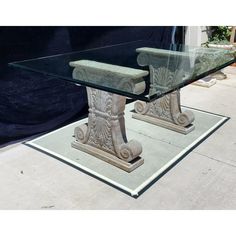 a glass table with two pedestals on it