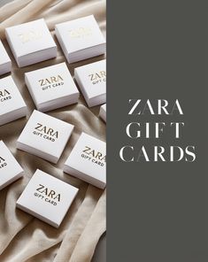 the zara gift cards are laid out on top of a blanket with gold lettering