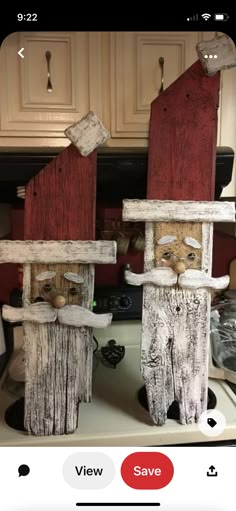 two wooden cats sitting on top of a stove