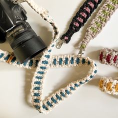 a camera and some crocheted items on a table