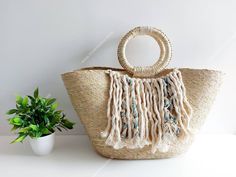 I love Mexico celebrates the native crafts of Mexico and the artists that produce them, enabling them and their communities to get recognized for their talented work and achieve economic stability for their families. This listing is for this bag shown on the picture, made of palm straw and 100% natural materials. The tassels or other accessories on the picture are not included. Measurements : please see pictures for exact size. All size units are in inches. The bag is very nicely made, strong an Eco-friendly Macrame Straw Bag For Vacation, Eco-friendly Macrame Straw Bag For Summer, Beige Macrame Beach Bag For Beach Season, White Bohemian Open Weave Straw Bag, Bohemian Crochet Bag With Macrame For The Beach, Eco-friendly Straw Bag With Weaving Details, Eco-friendly Straw Bag With Weaving, Beige Macrame Beach Bag, Eco-friendly Straw Weaving Bag