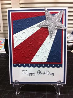 a happy birthday card with a star on the front and red white and blue background