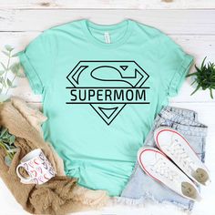 "Super Mom Shirts, Mother's Day Shirt, Supermom Shirt, Mother's Day Gift, Super Mother Tee, Super Mom Gift Shirt, Mother's Day Gift HOW TO ORDER Please, check and review all photos Choose your custom text, font option, and text color. Choose your size from the drop-down menu and add each shirt to your cart one at a time. Click add to cart. You can go back to add more product Click \"Proceed to check out\" When you check out, you can add a note to the seller for any request Youth, toddler unisex Mom Avengers Shirt, Super Mom T Shirt, Super Mom Shirt, Super Mom, Mothers Day Shirts, Mom Gift, Mother's Day Gift, Mom Shirts, Maryland