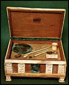 an old wooden box with various items in it