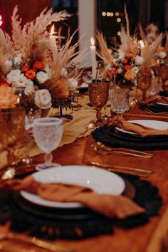 the table is set with plates and place settings