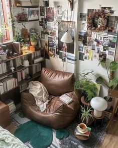 a living room filled with furniture and lots of books on the shelves next to a window