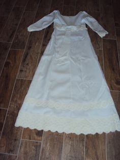 "Beautiful White Modest Linen And Venetian Lace Bridal Gown Size XS- S Excellent Vintage Condition, No Rips Or Tears, A Few Light Stains On The Bottom Inside Lining Of Train Fully Lined Empire Waist Dress Elbow Length Sleeves Rounded Boat Neckline Back Metal White Zipper (Zips Fine Too Small For My Dress Form) 6\" X 1.75\" White Bow Attached In Back Several Rows Of 3-5\" Venetian Lace Lace Is Slightly Differnt Shade Of White Very Fitted Bodice With Darts And Venetian Lace Around Empire Waist A L Vintage Floor-length Wedding Dress With Fitted Bodice, Full Length Victorian Dress For Wedding, Floor-length Vintage Wedding Dress With Fitted Bodice, Floor-length Dresses With Lace Trim For Ceremony, Fitted Wedding Dress With Lace Trim For Debutante Ball, Formal Ball Gown With Lace Trim, Ceremonial Gown With Lace Trim And Fitted Bodice, White Wedding Dress With Lace Trim For Formal Occasion, Formal White Wedding Dress With Lace Trim