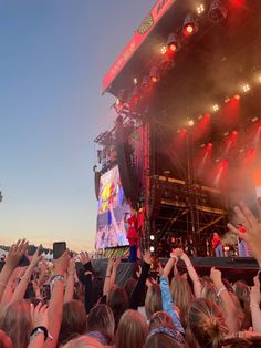 a crowd of people standing on top of a stage