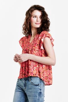 image of a female model wearing a VAYDA SMOCKED YOKE SHIRT AUTUMN PAISLEY DEAR JOHN DENIM Chic V-neck Smocked Top For Vacation, Casual V-neck Top With Smocked Back, V-neck Smocked Top With Smocked Bodice For Vacation, Summer V-neck Top With Smocked Bodice, Spring Smock V-neck Blouse, Bohemian V-neck Top With Smocked Back, Bohemian V-neck Tops With Smocked Back, Spring V-neck Smock Blouse, Flowy Smocked Bodice Top With Short Sleeves