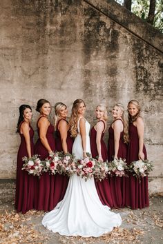 the bride and her bridesmaids are all wearing burgundy dresses