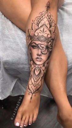 a woman's leg with tattoos on it