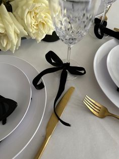 the table is set with black and white place settings