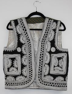 A rare find vintage sleeveless waistcoat from Afghanistan. Size: S/M Bust: 16.5 Inches Height: 20 Inches Note: Worn and minor signs of wear. Traditional Black Sleeveless Vest, Fitted Vintage Vest With Embroidery, Vintage Embroidered Fitted Vest, Black Vintage Vest For Spring, Vintage Fitted Embroidered Vest, Vintage Black Vest For Spring, Fitted Sleeveless Vest For Festival, Traditional Summer Vest, Traditional Sleeveless Summer Vest