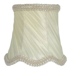 a white lamp shade with beading on it