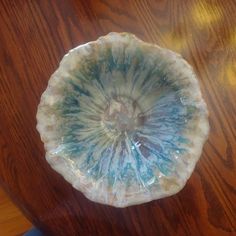 a piece of glass sitting on top of a wooden table