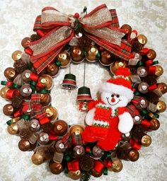 a christmas wreath with a teddy bear and bells