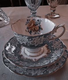 an antique tea cup and saucer on a table