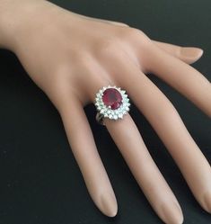 8.50 Carats Impressive Red Ruby and Natural Diamond 14K White Gold Ring Total Red Ruby Weight is: Approx. 7.00 Carats Ruby Treatmen: Lead Glass Filling Ruby Measures: Approx. 11.00 x 9.00mm Natural Round Diamonds Weight: Approx. 1.50 Carats (color G-H / Clarity SI1-SI2) Ring total weight: Approx. 6.70 grams Disclaimer: all weights, measurements and colors are approximate and may vary slightly from the listed dimensions or as seen in the image. All pictures are magnified to show the smallest of d Red Round Cluster Ring For Formal Occasions, Formal Ruby Cluster Ring With Round Shape, Formal Red Cluster Ring With Prong Setting, Red Cluster Ring With Prong Setting For Formal Occasions, Red Cluster Ring With Prong Setting For Formal Events, Formal Red Diamond Cluster Ring, Red Diamond Cluster Ring For Formal Occasions, Classic Red Cluster Ring For Formal Occasions, Formal Red Halo Ring