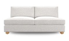 a white couch sitting on top of a wooden floor