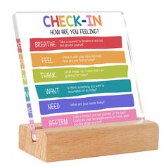 a wooden stand with a sign that says check - in how are you feeling?