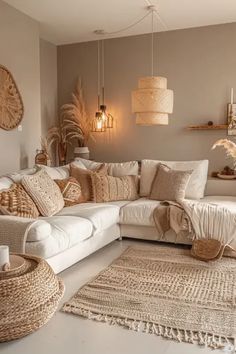 a living room filled with white furniture and lots of pillows on top of the couch