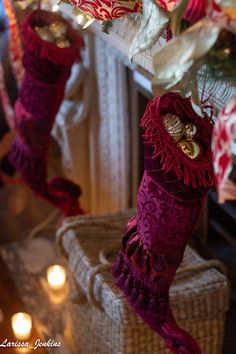 christmas stockings hanging from a fireplace with candles