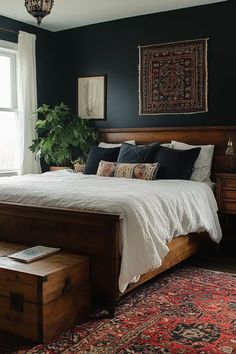 a bedroom with a bed, dresser and rug on the floor in front of a window