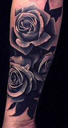 a black and white rose tattoo on the arm